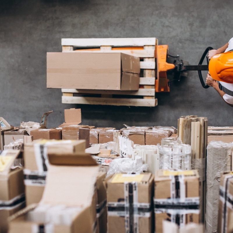 Young man working at a warehouse with boxes